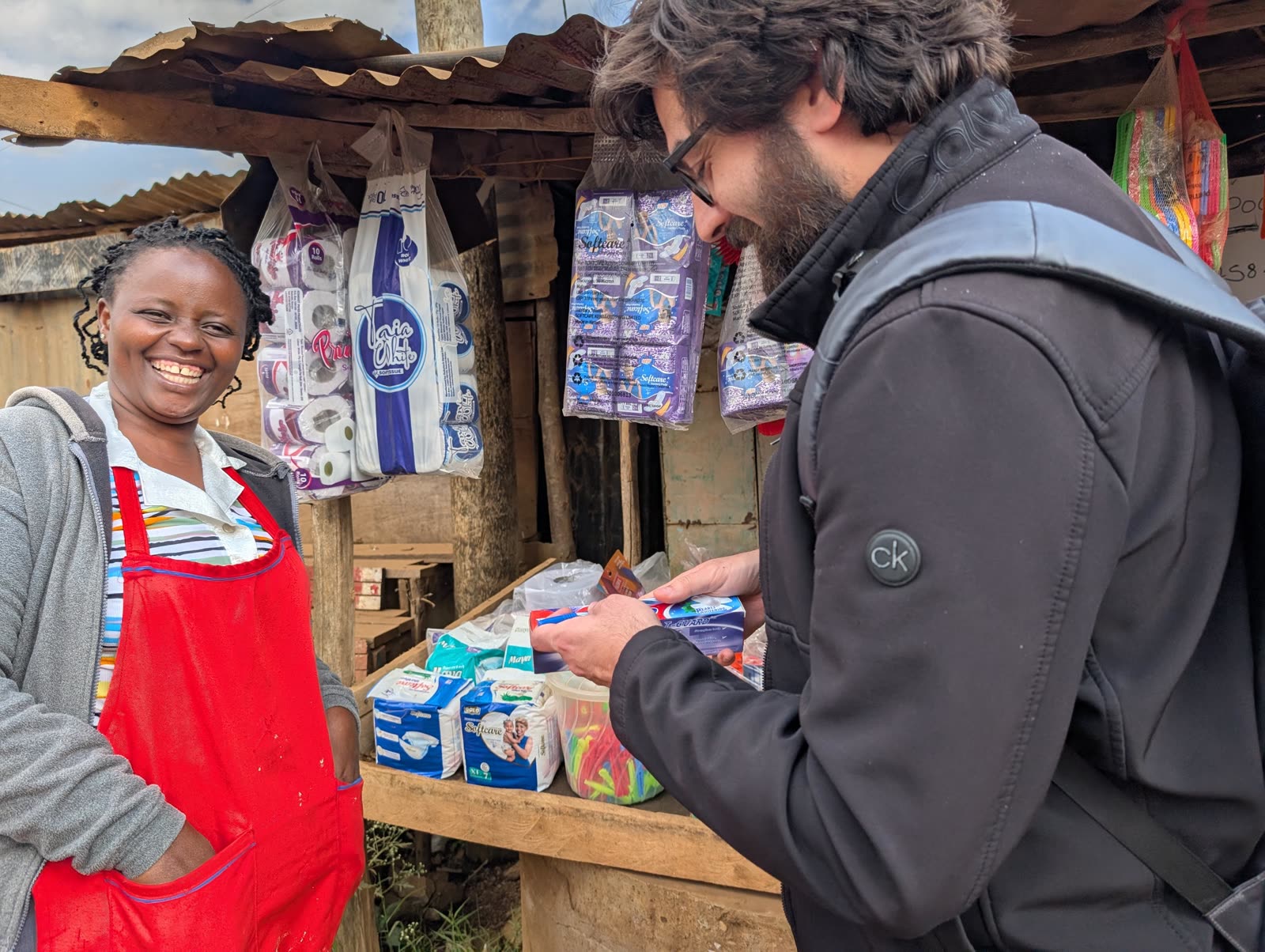 A smiling merchant sells diapers and baby supplies for Bitcoin at her shop in Matangi, Kenya