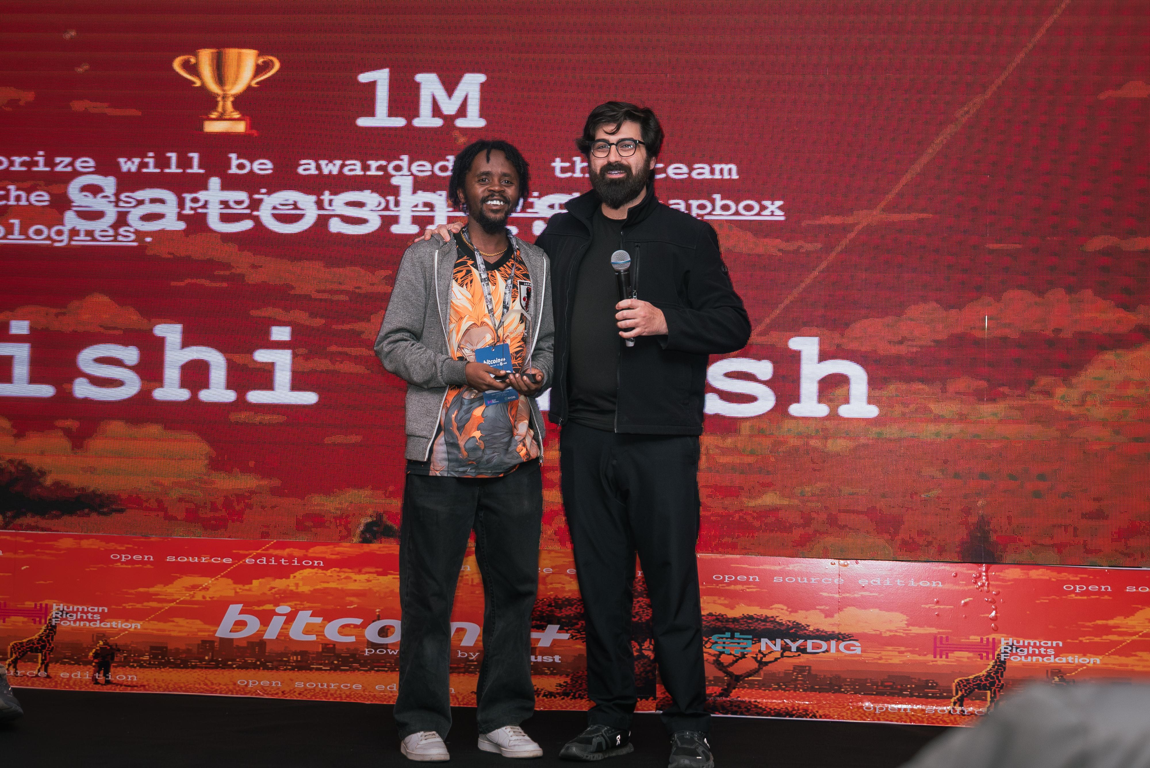 Alex Gleason awards a hackathon prize at BTC++ Nairobi